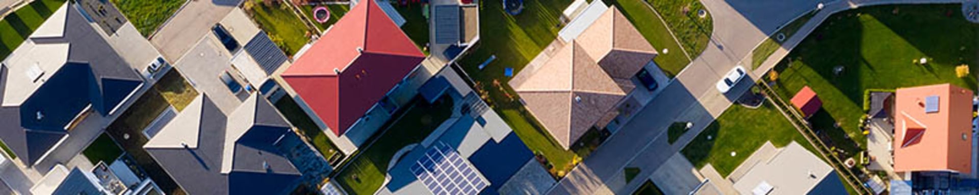 Aerial view of a residential neighborhood showcasing houses, streets, and green spaces.