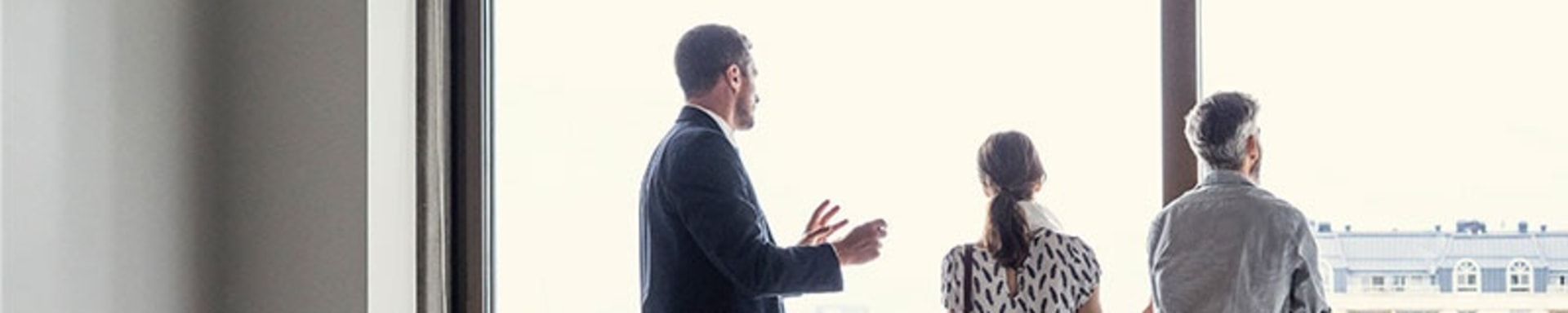 A married couple examines the view of a property, symbolizing a move.