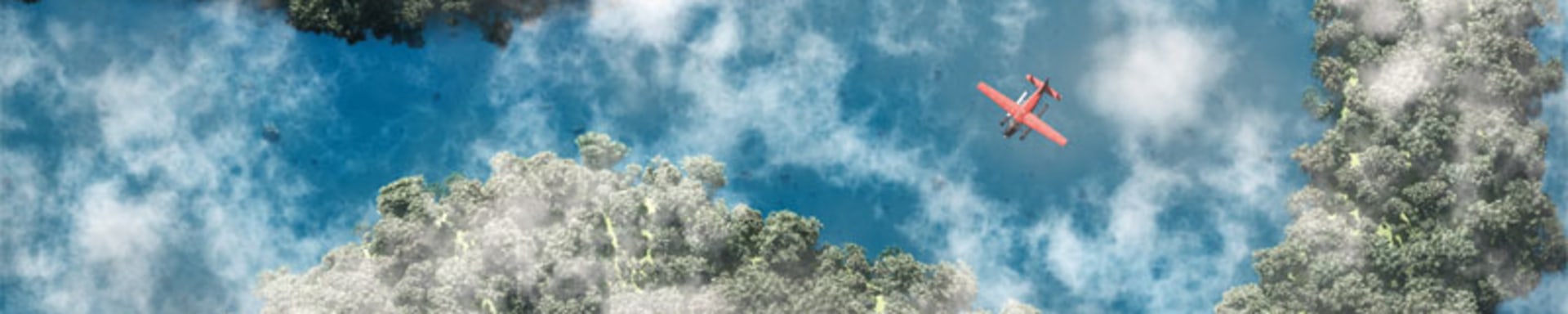 A plane soaring above a winding river and lush trees.