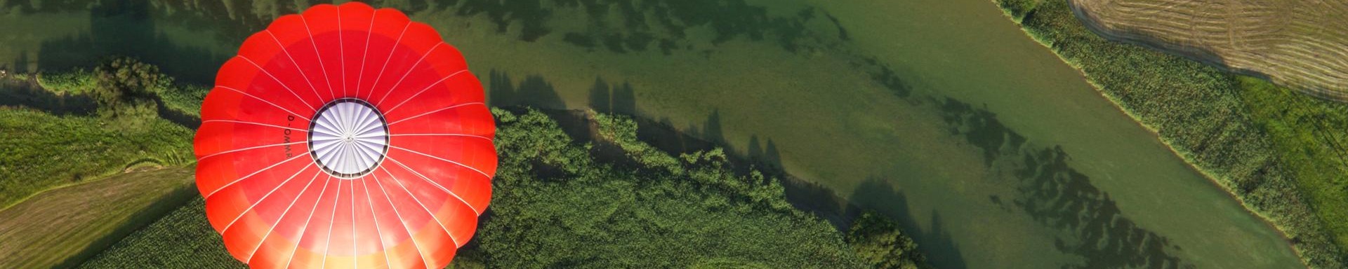 Picture of a hot red air baloon with a green background.