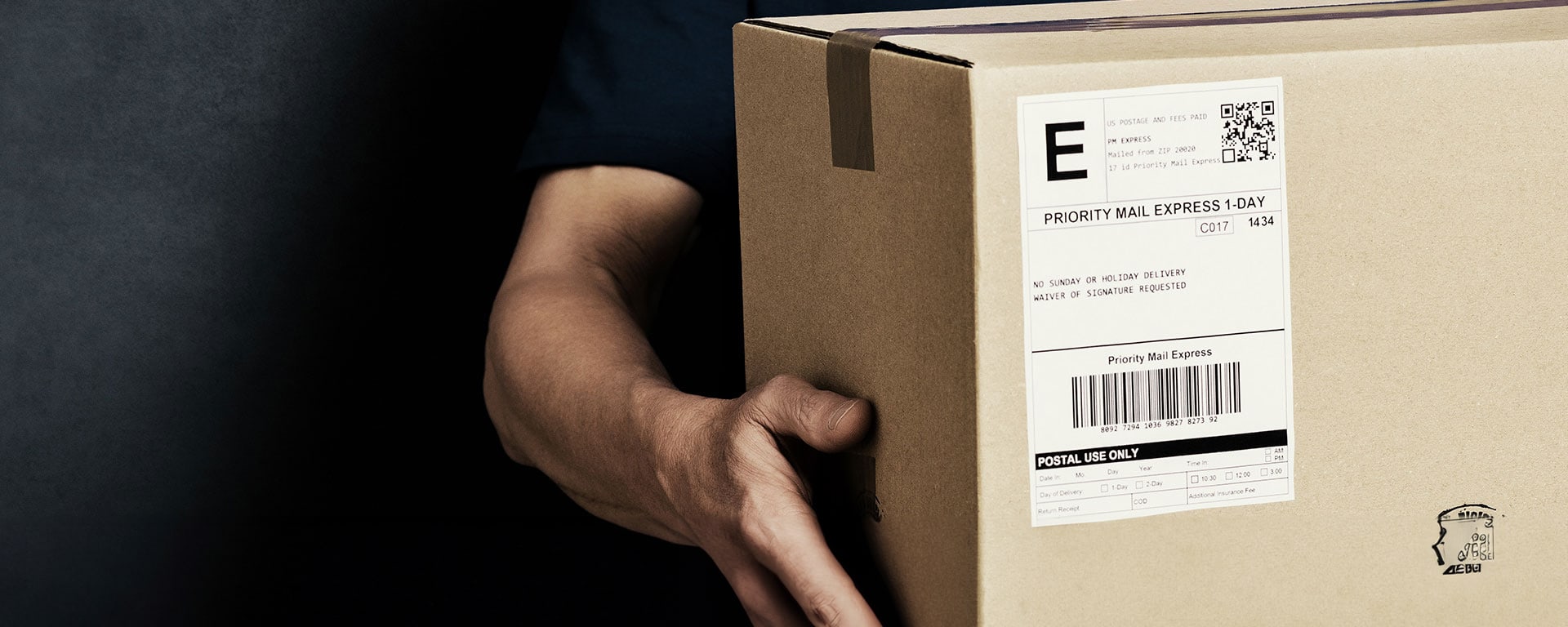 Image of a man holding a box.