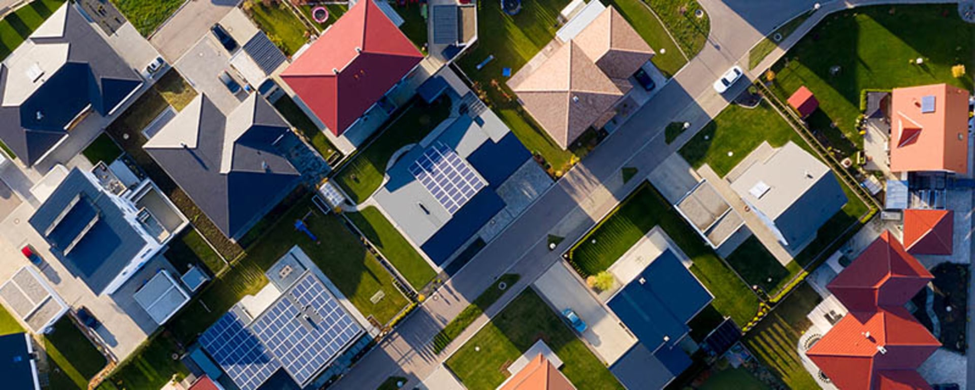 Aerial view of a residential neighborhood showcasing houses, streets, and green spaces.