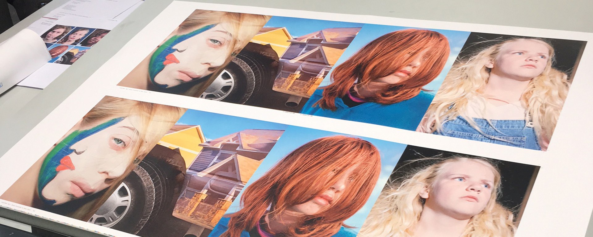 A photo of various portraits being prepared for printing.
