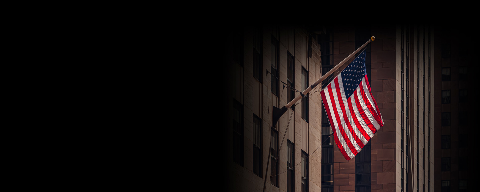 Eine amerikanische Flagge flattert im Wind. US-Wahlen: Ein entscheidender Moment für Ihr Portfolio aus Sicht der Anleger.