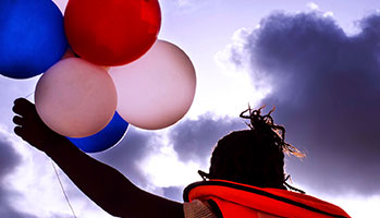 A person joyfully holds a bunch of colorful balloons, creating a vibrant and cheerful atmosphere.