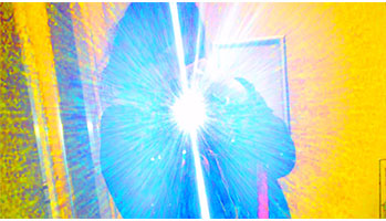 Person taking a selfie with blue light and yellow background.