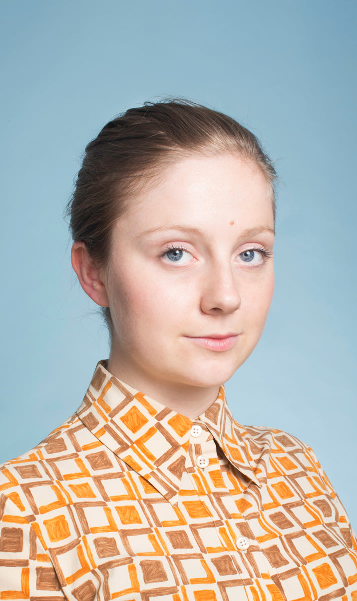 Portrait of Eva O'Leary with a blue background