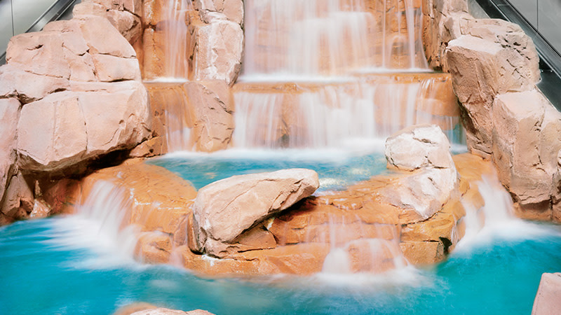 Art Vontobel Image Viewing - A waterfall cascading down a stone cliff.