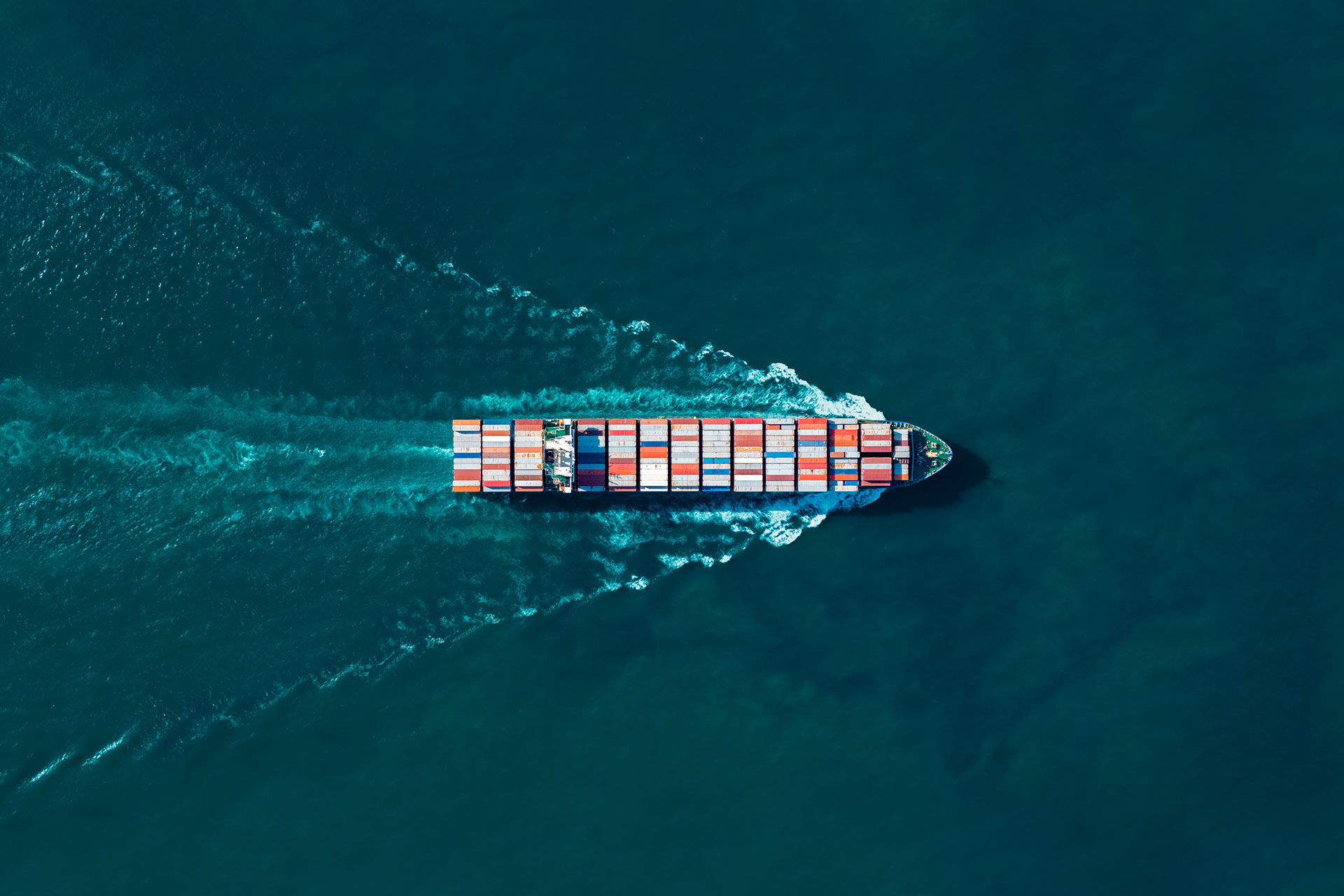 Aerial view of a container ship transporting global cargo across the ocean