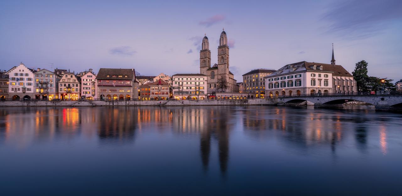 Photo of the city of Zürich showing some of the old buildings and part of the lake