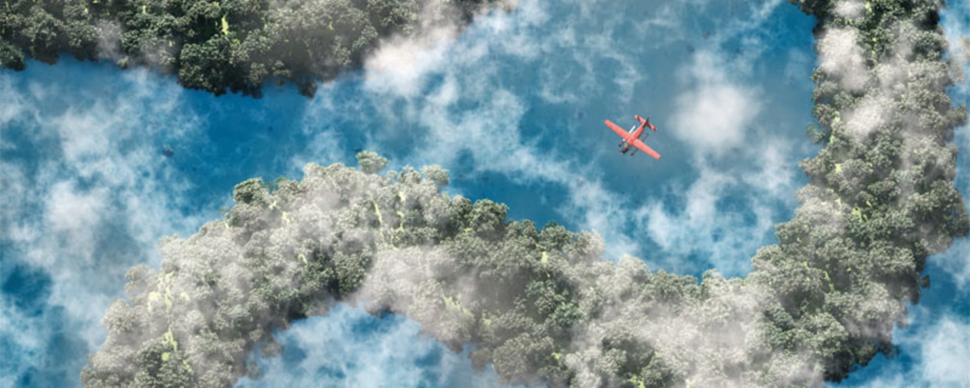 A plane soaring above a winding river and lush trees.