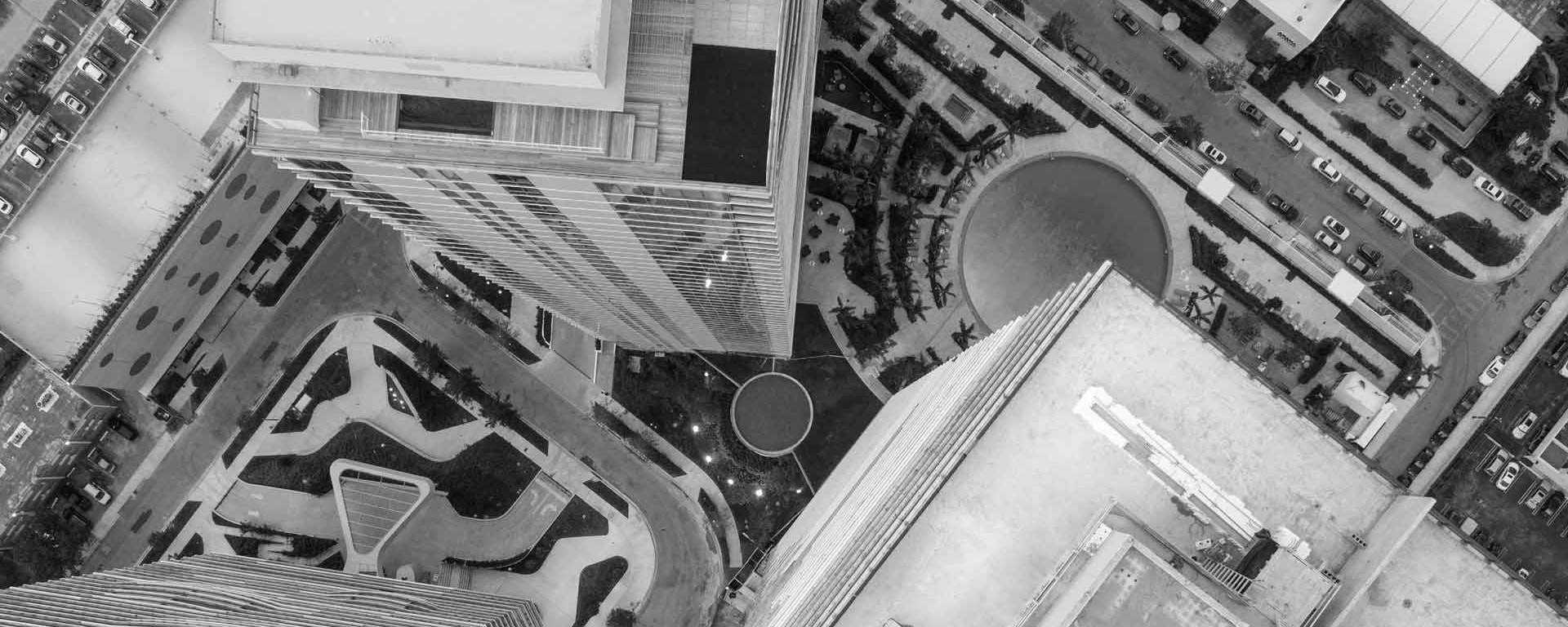 A black and white picture of a skyscraper from a bird's-eye view.