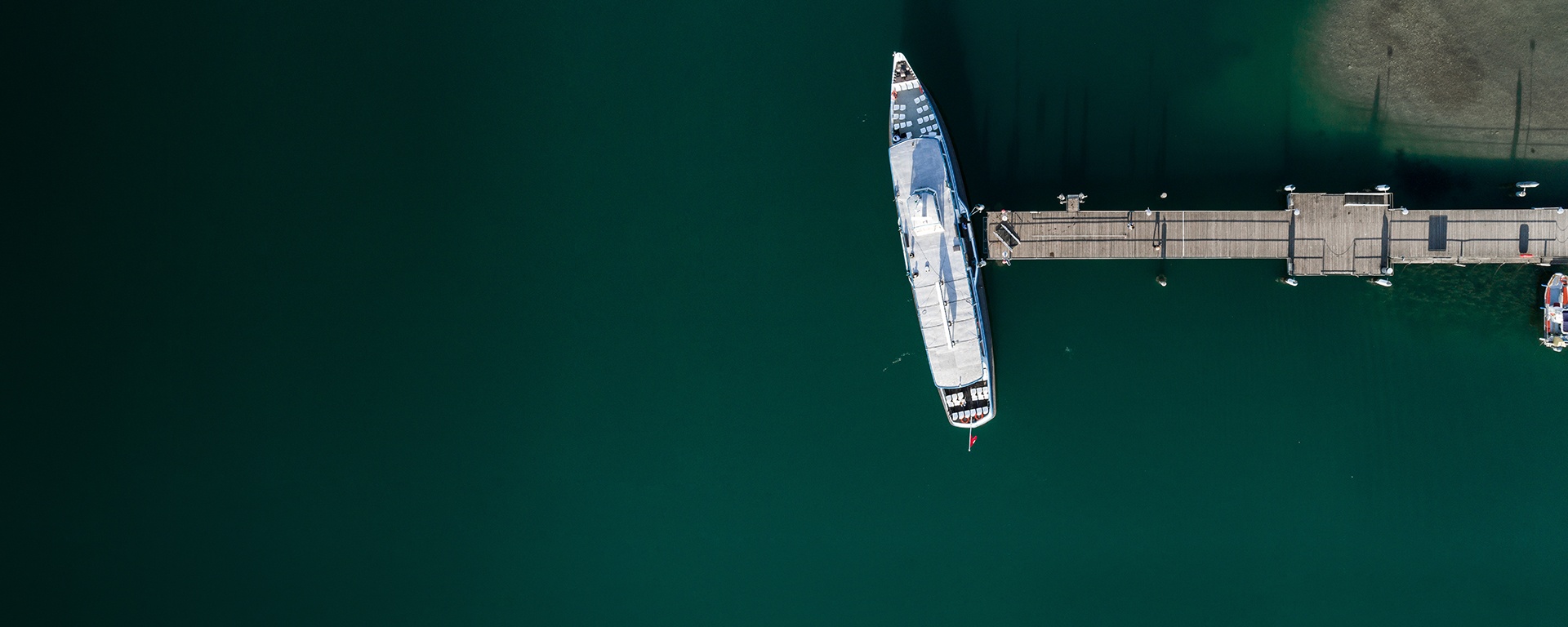 A large ship is anchored at a pier. Photo from a bird's eye view.