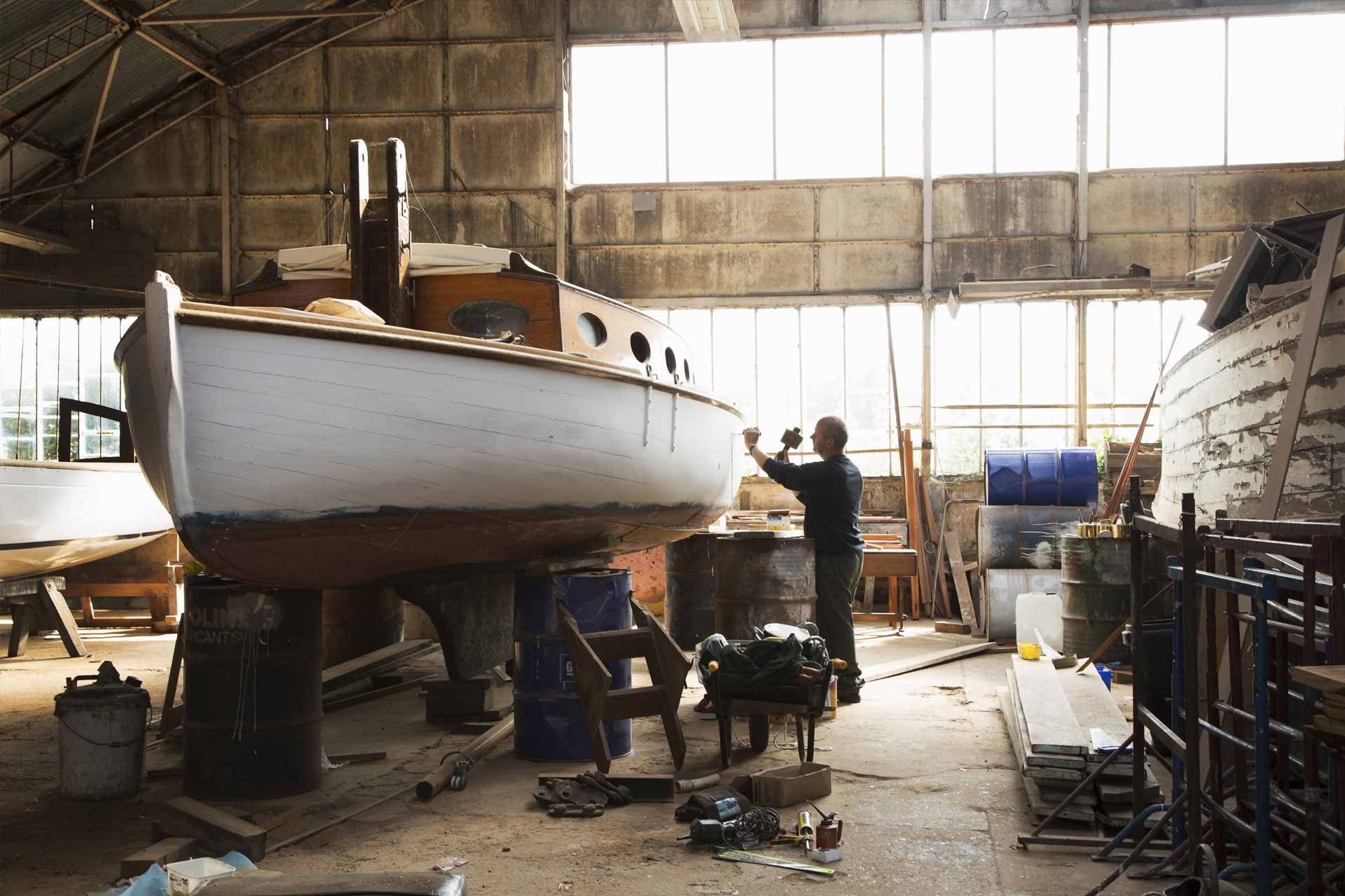 A man builds a boat on his own