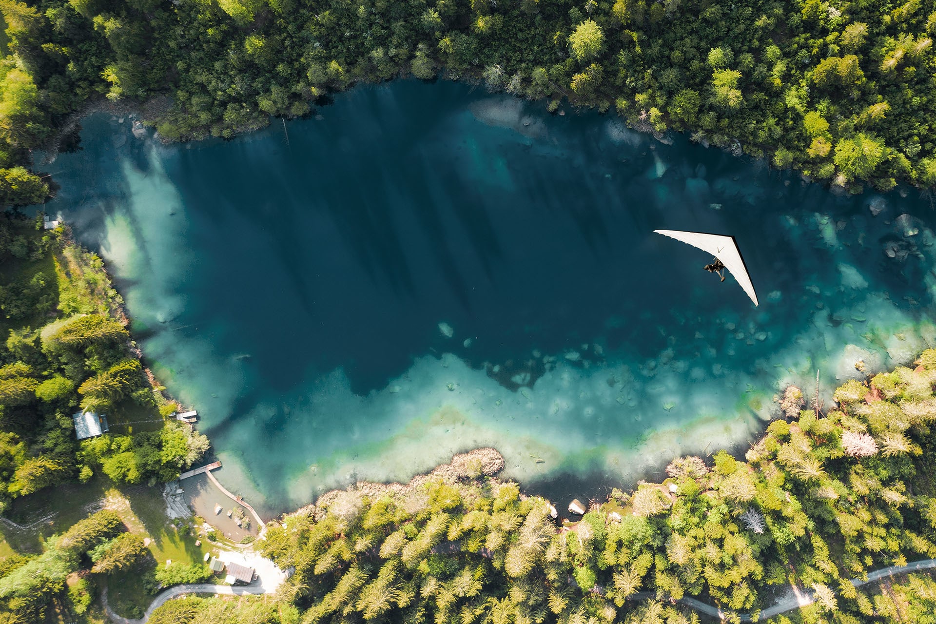 3 building blocks for a strong portfolio - Flyer flying over a mountain lake in the forest. 